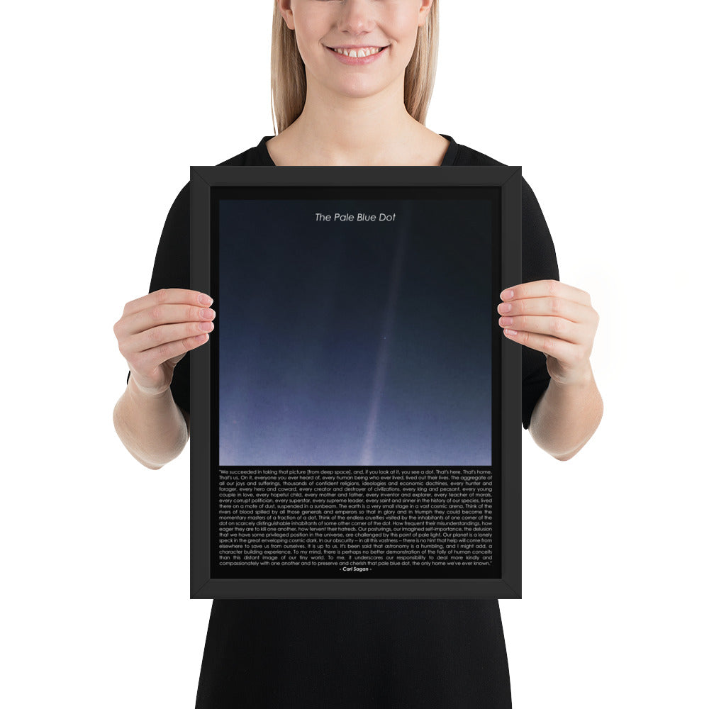 Woman holding The pale blue dot framed poster with Carl Sagan quote