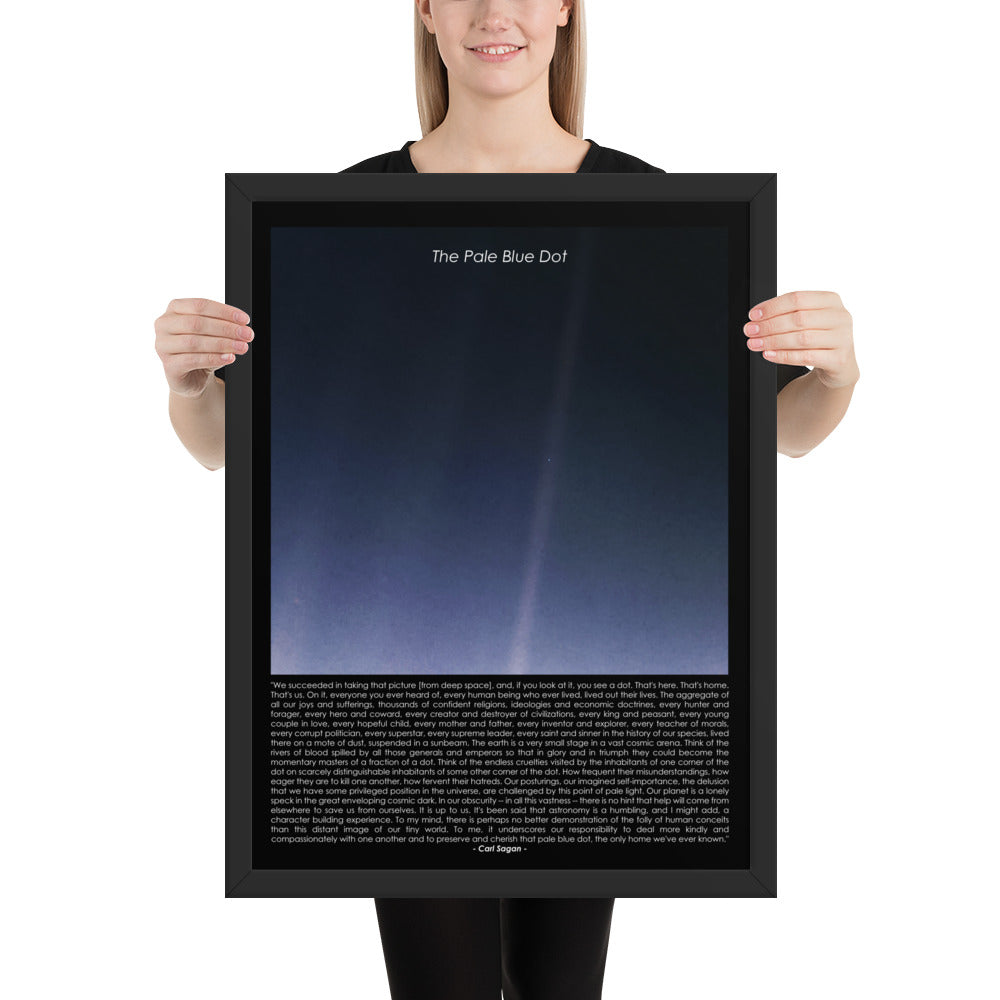Woman holding The pale blue dot framed poster with Carl Sagan quote