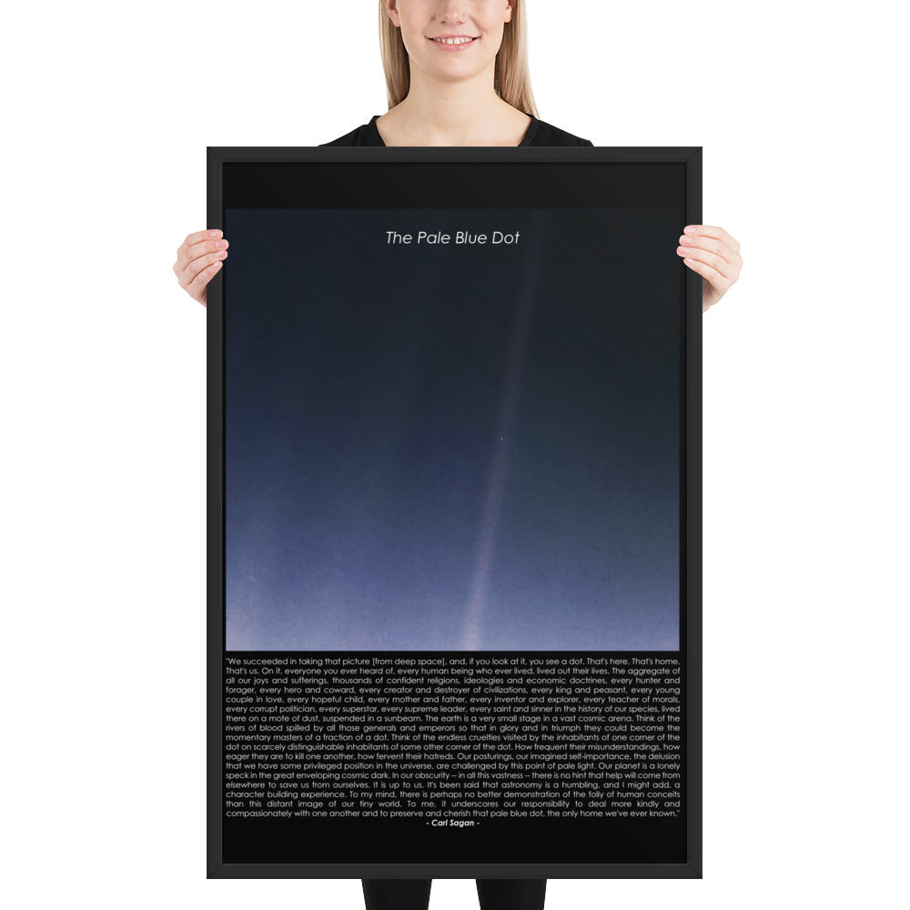 Woman holding The pale blue dot framed poster with Carl Sagan quote