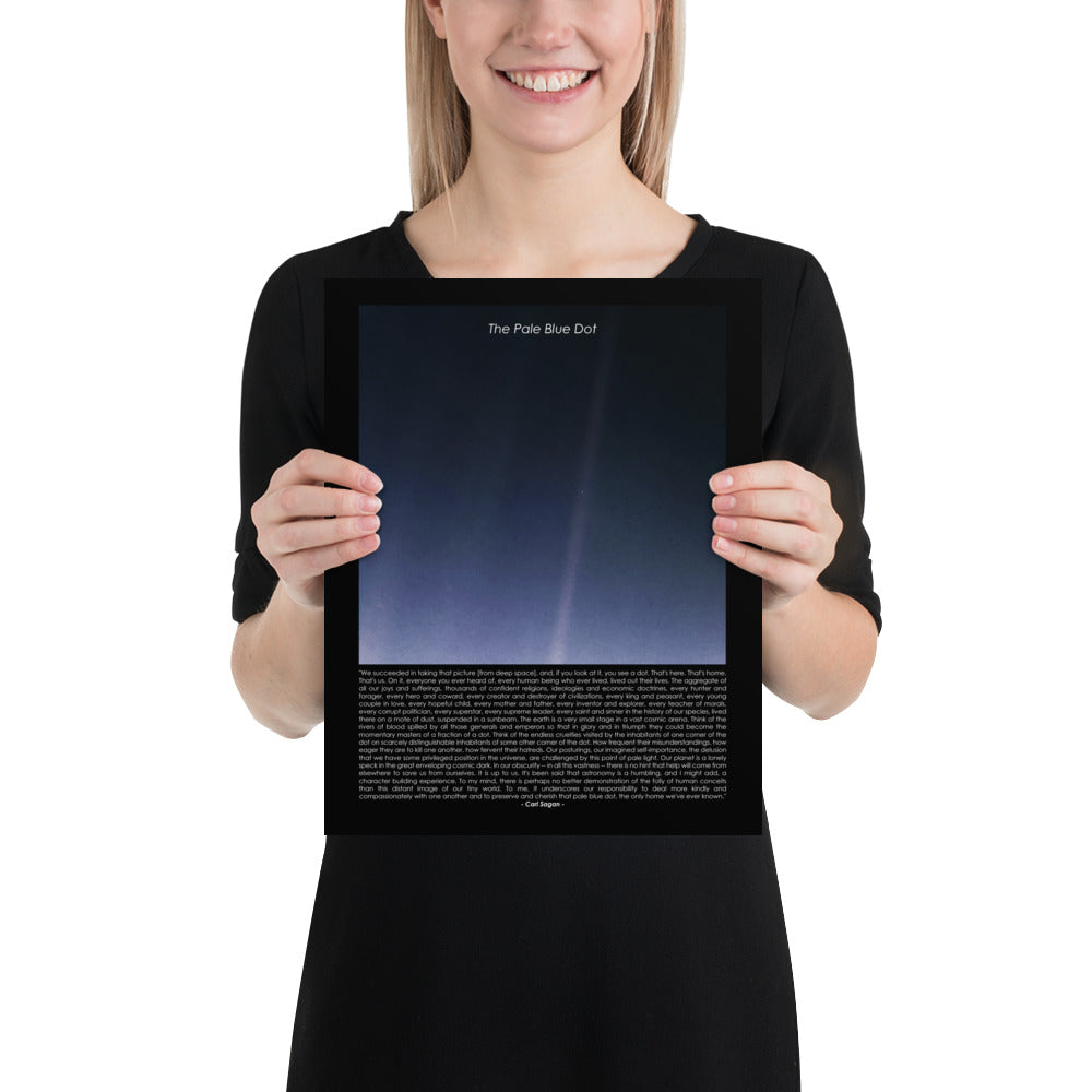 Woman holding The pale blue dot poster with Carl Sagan quote