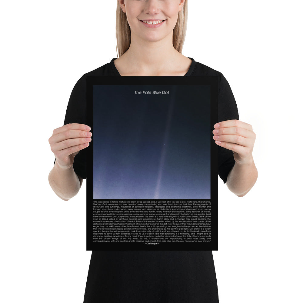 Woman holding The pale blue dot poster with Carl Sagan quote