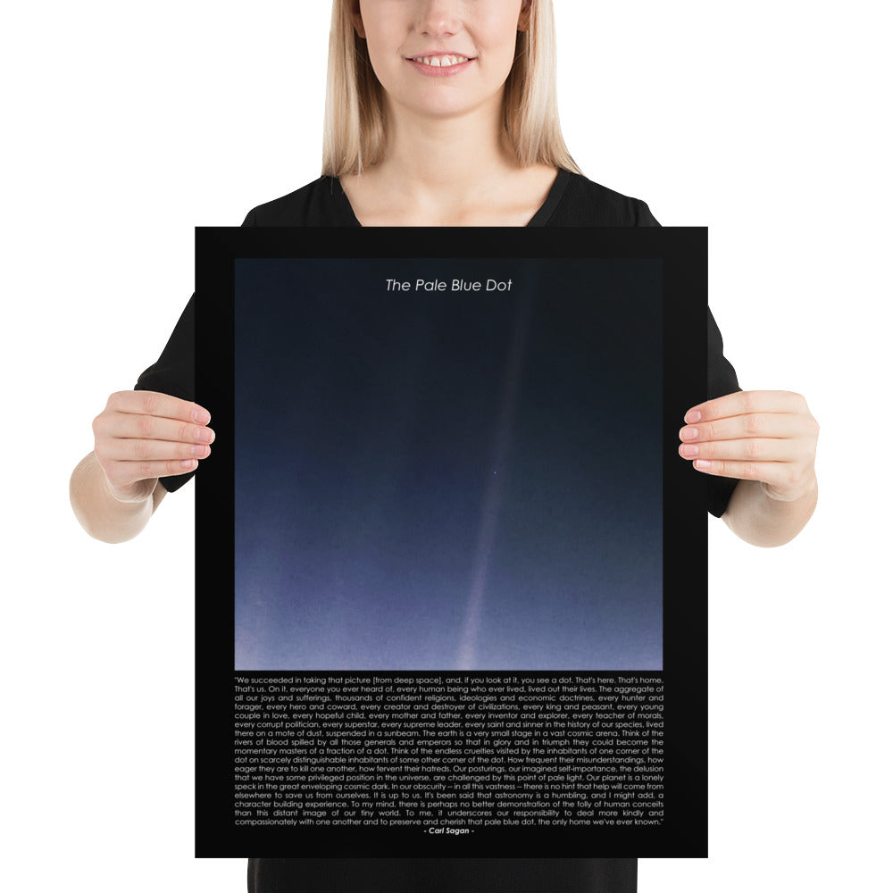 Woman holding The pale blue dot poster with Carl Sagan quote