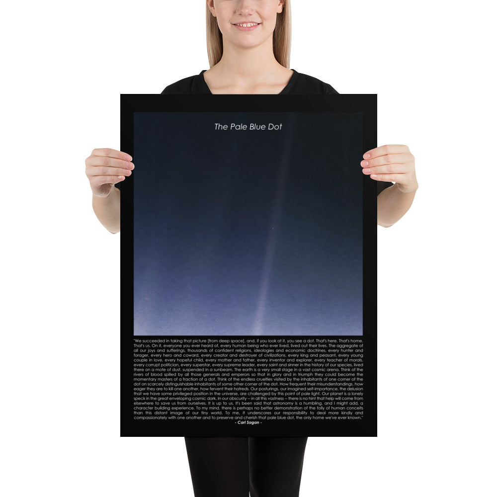 Woman holding The pale blue dot poster with Carl Sagan quote
